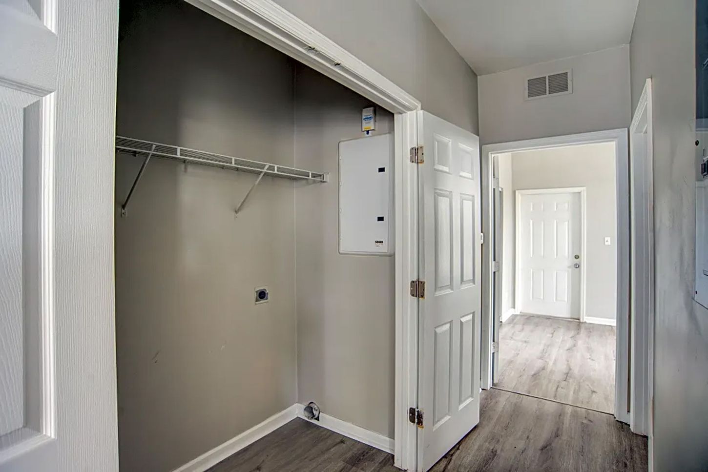 A closet in a house with a washer and dryer in it.