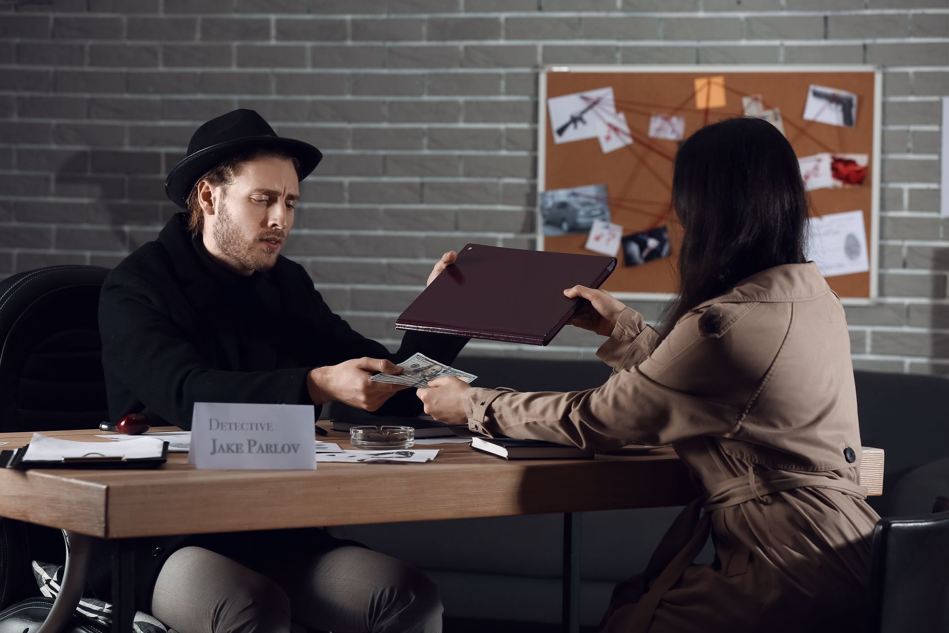 Young woman hiring a private detective for crime investigation.