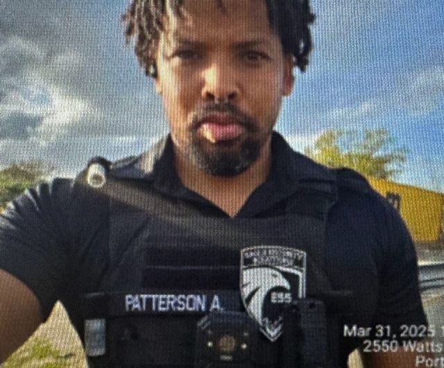Man wearing a black uniform, name tag