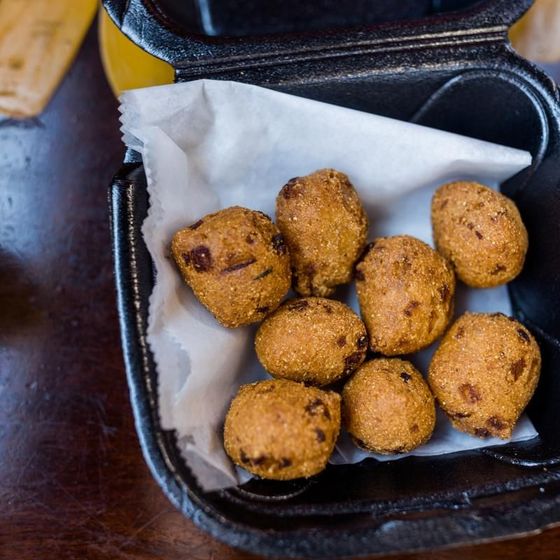 A styrofoam container filled with fried food balls