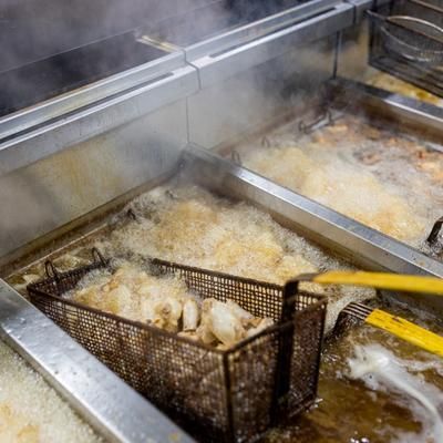 A basket of food is being cooked in a fryer.