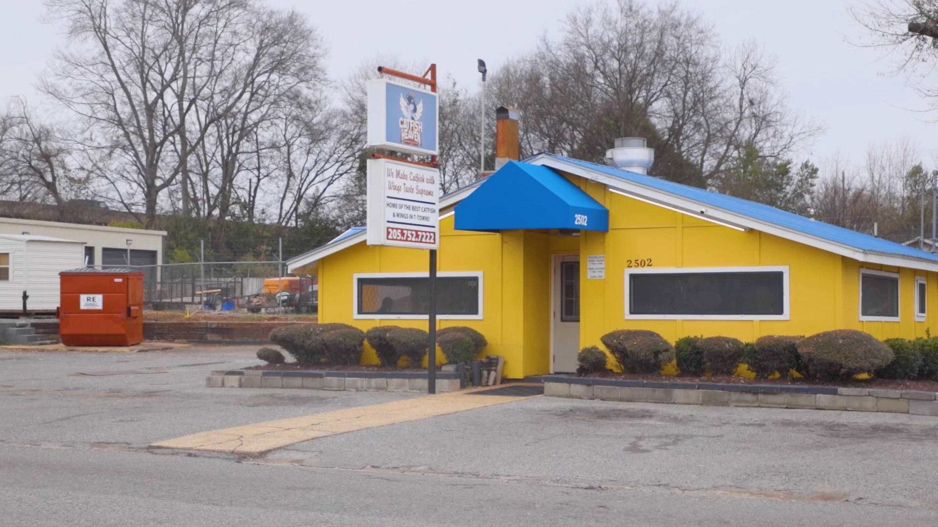 A yellow building with a blue awning on top of it