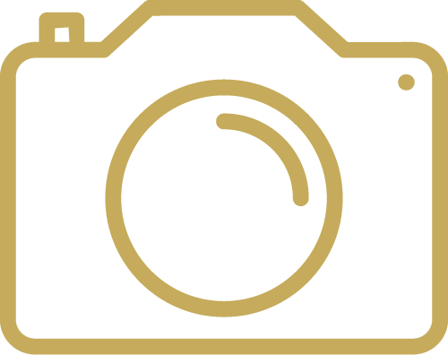 A gold icon of a camera on a white background.