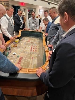 A group of men are playing a game of craps at a table.