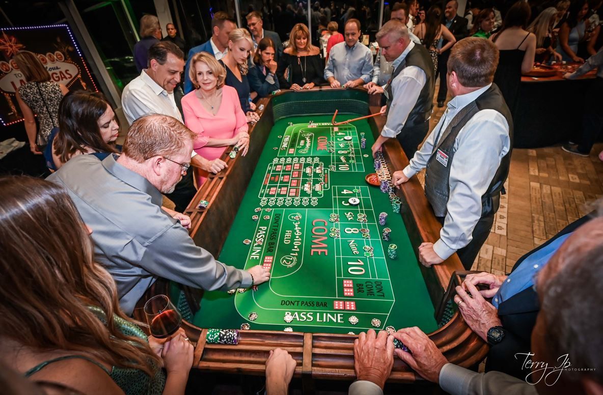 Woman blackjack dealer setting cards on table.