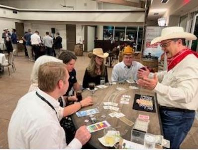 People seated around a table playing cards at a casual indoor gathering