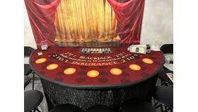 Blackjack table with red-and-gold backdrop and betting circles in a casino-style setting