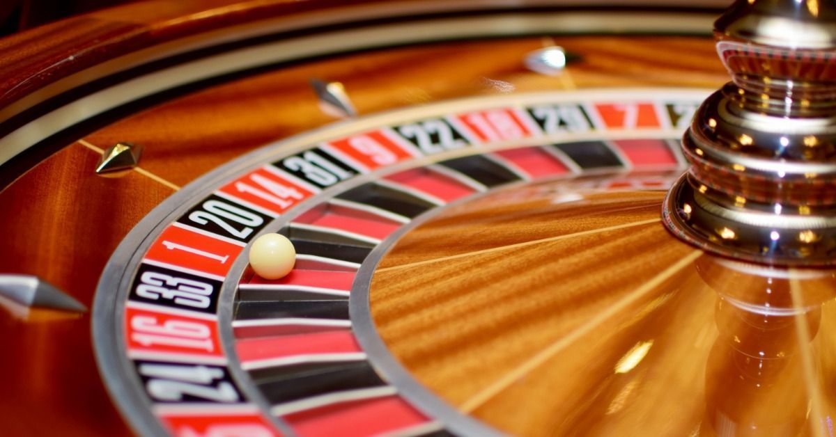 Close-up of a roulette wheel. The white ball has stopped on the number 1, in between slots for 33 and 20.