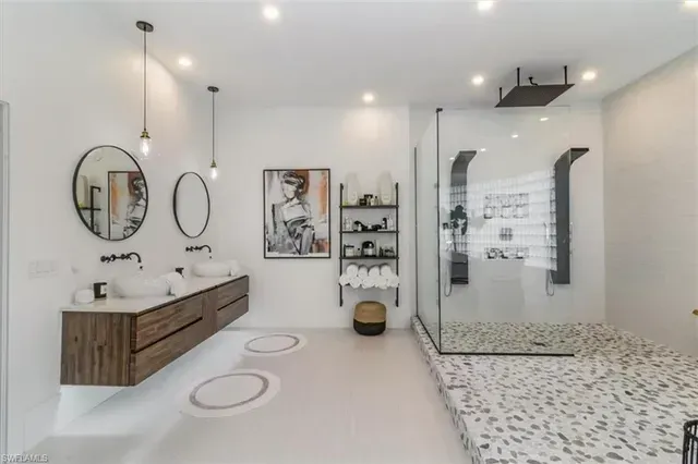 Modern spa bathroom with double vanity, large mirror, glass shower, and patterned tile floor at CRAFTED 1111 fashion