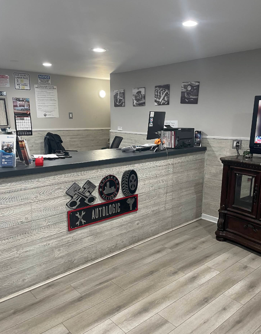Interior of a auto repair shop with a front counter, black decor, and wood-look flooring | Auto Logic Complete Auto Repairs