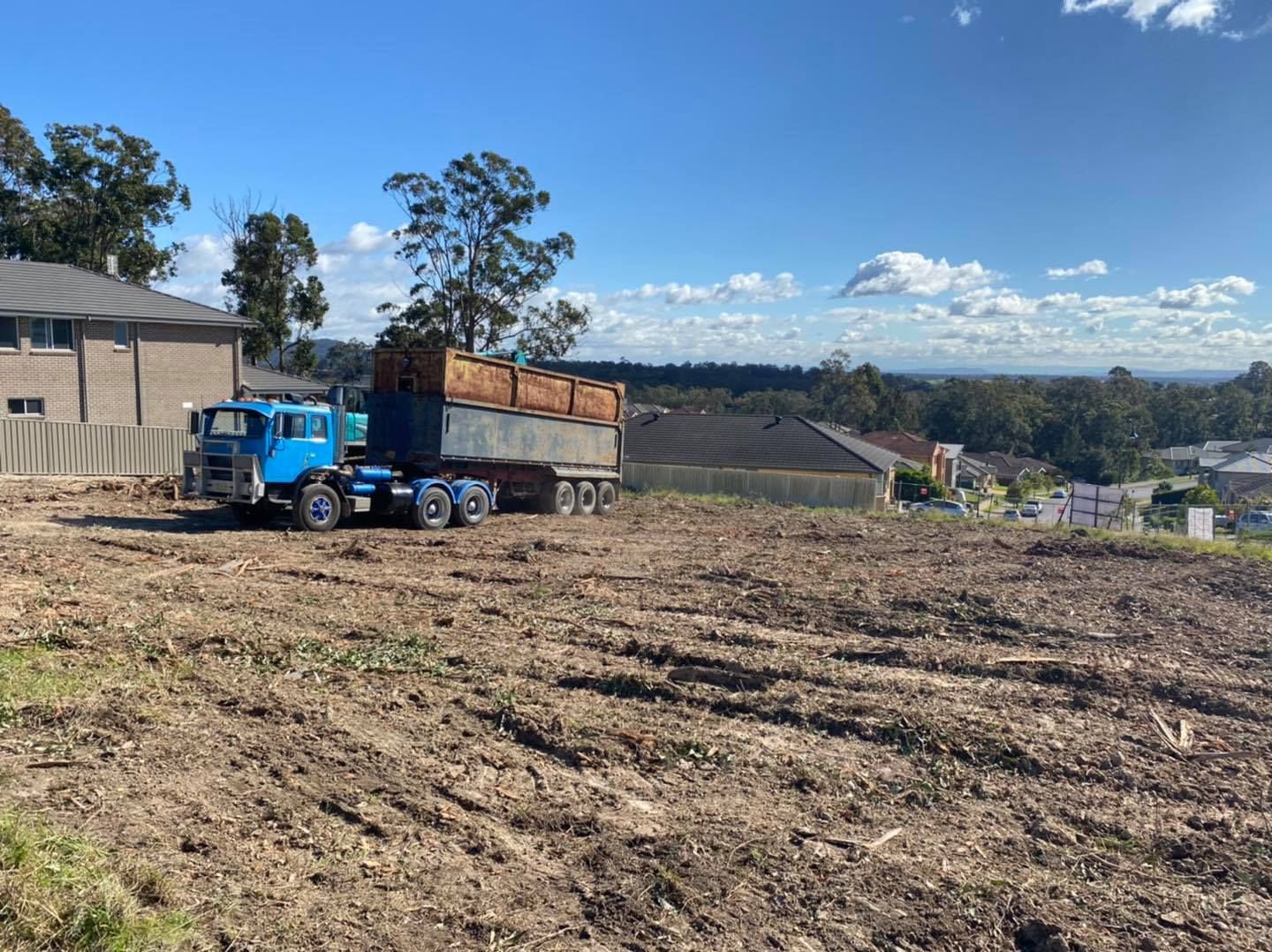Blue Truck Hauling a Full Trailer of Wood Chips — Chop n Drop Tree Specialists in Lake Macquarie, NSW