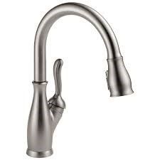 Brushed nickel kitchen faucet with a curved spout and pull-down sprayer.