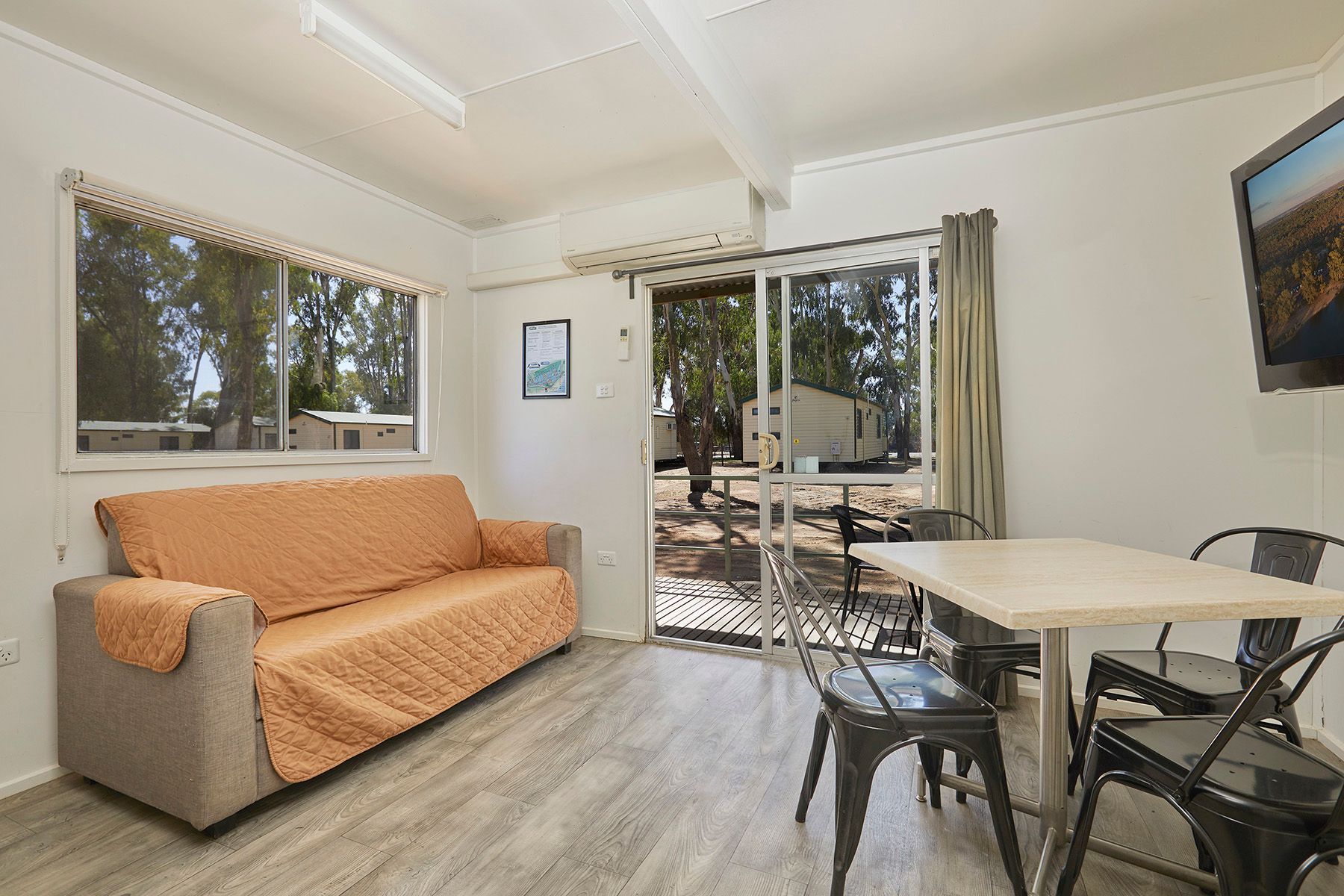 Apex Riverbeach Holiday Park Cabin lounge with table and chairs and comfy sofa, suitable for pets