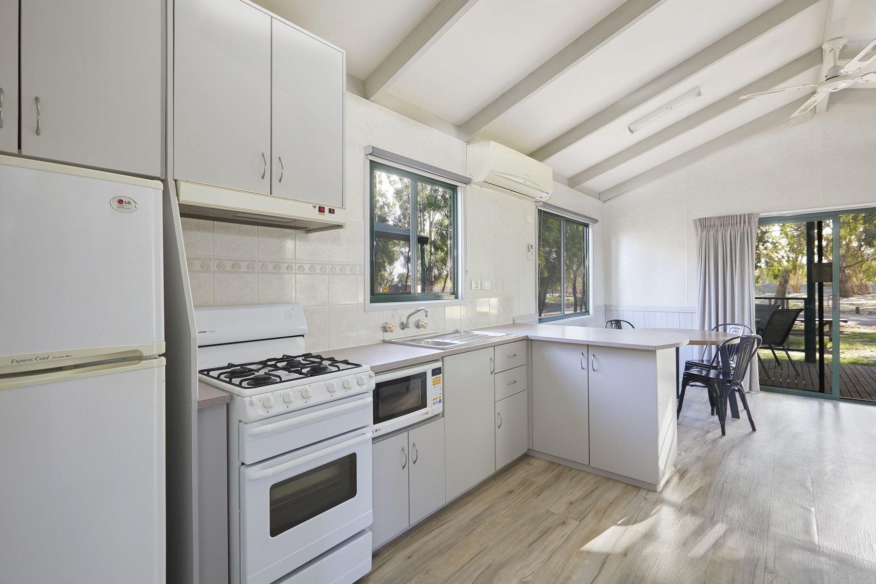 Apex Riverbeach Holiday Park cabin with table and chairs , kitchen