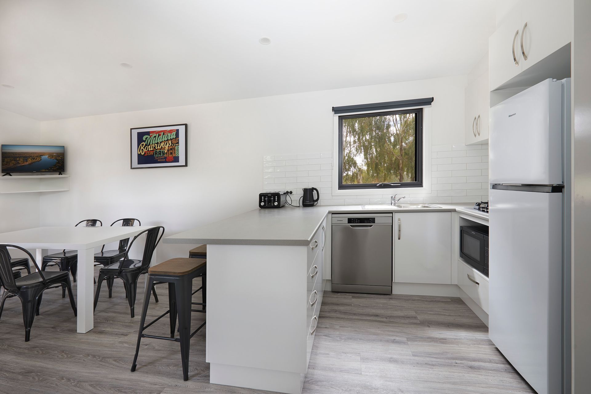 Apex Riverbeach Holiday Park cabin with bar stools , table and chairs , full kitchen