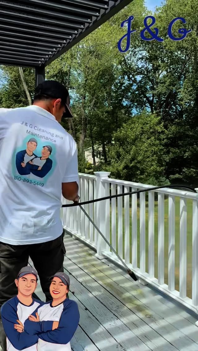 Person on a white bridge wearing a white shirt with a graphic, under a pergola in a tree-lined park.