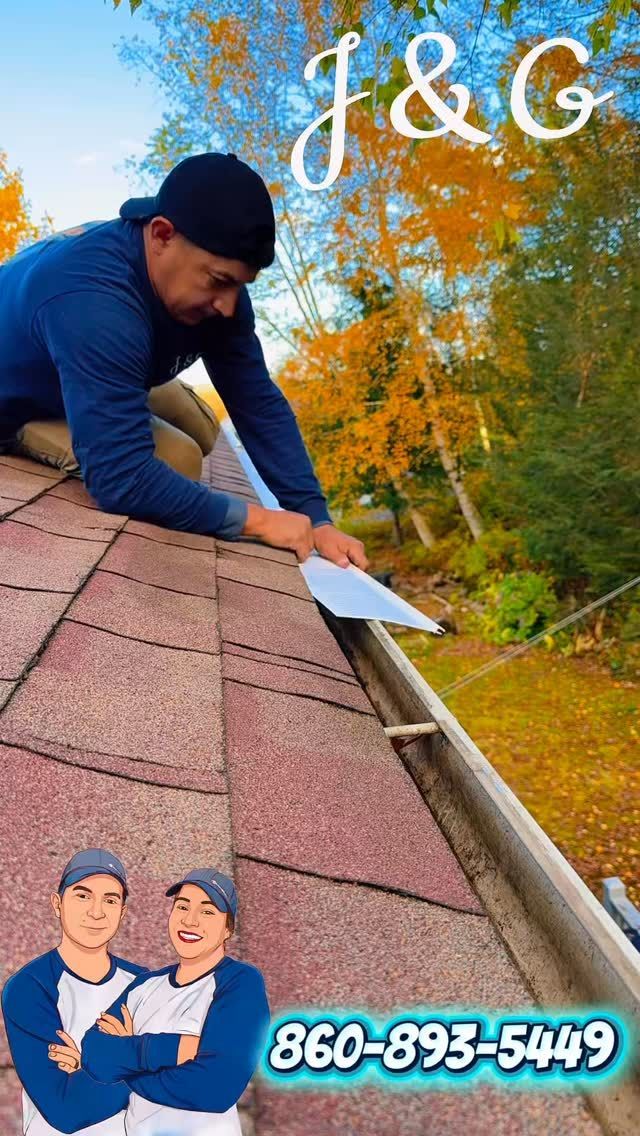 Worker using a scraper to clear a shingle roof, with J&G branding and phone number 860-893-5449.