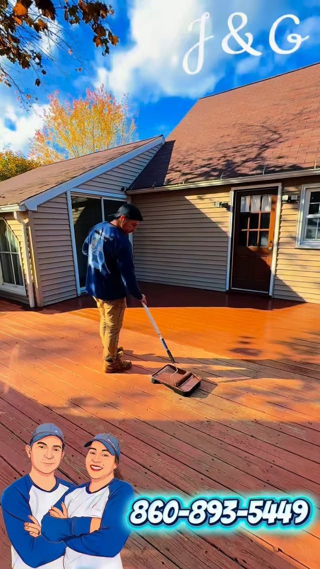 Worker cleaning orange roof and siding on a house, with company logo and phone number overlay.