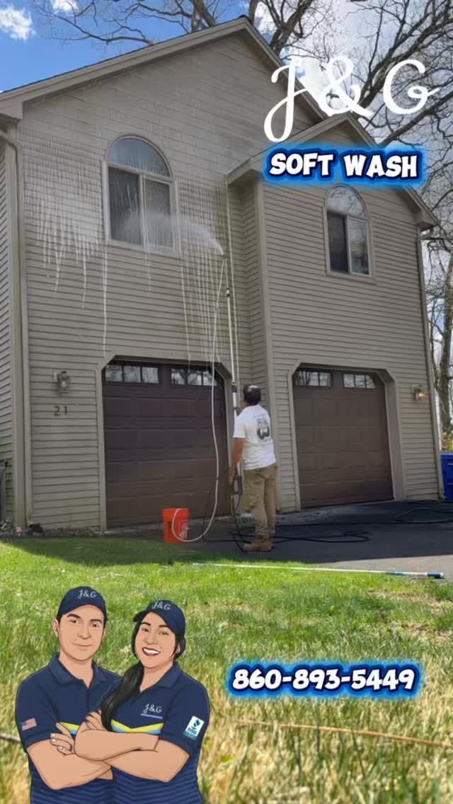 Soft wash worker cleaning a house exterior with a pressure washer; business logo and phone number shown.