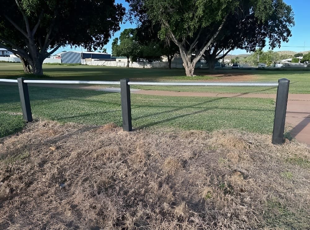 A Fence In A Park With Trees In The Background — PH Davie in Mount Isa, QLD