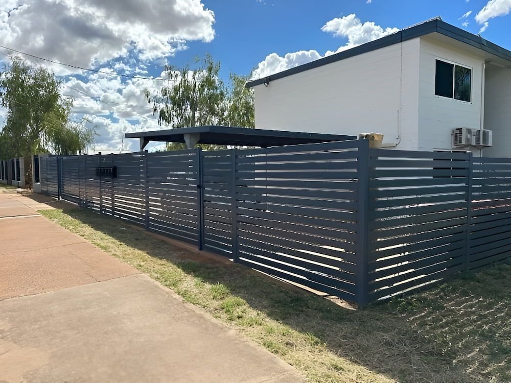 A Black Fence Is Surrounding A White House With Aluminum Slat — PH Davie in Cloncurry, QLD
