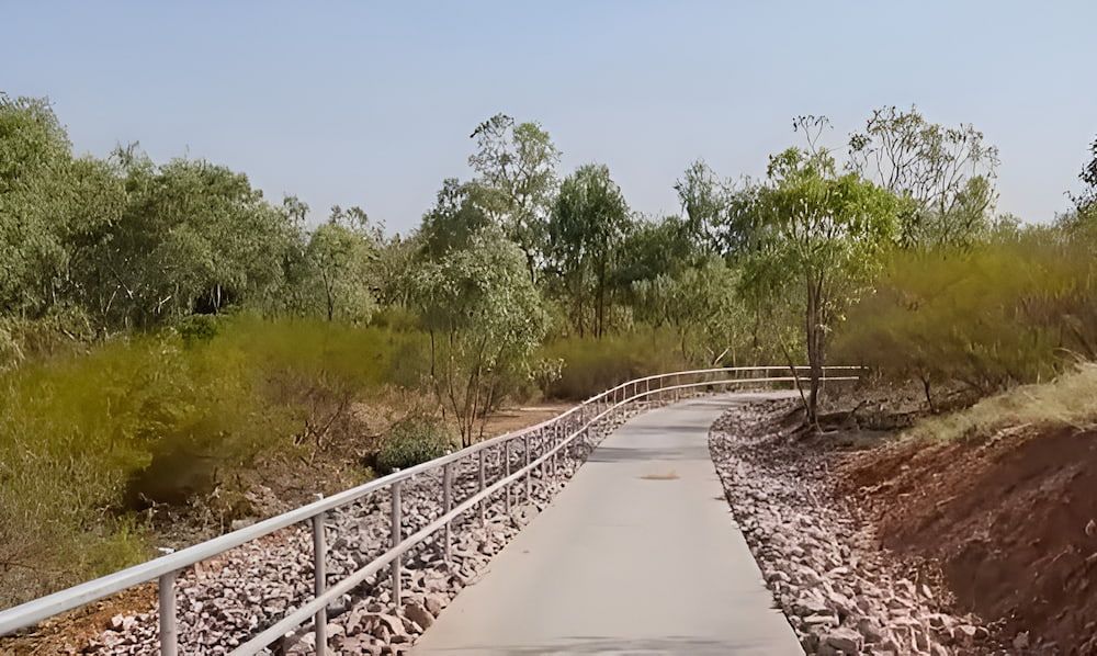 A Concrete Path With A Metal Railing Going Through A Forest — PH Davie in Cloncurry, QLD