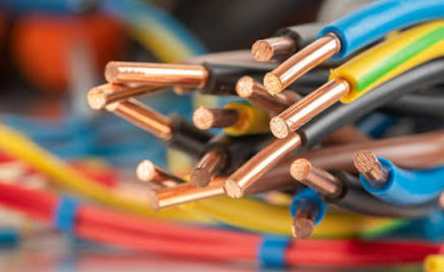 Close-up of multicolored electrical wires with exposed copper ends clustered together