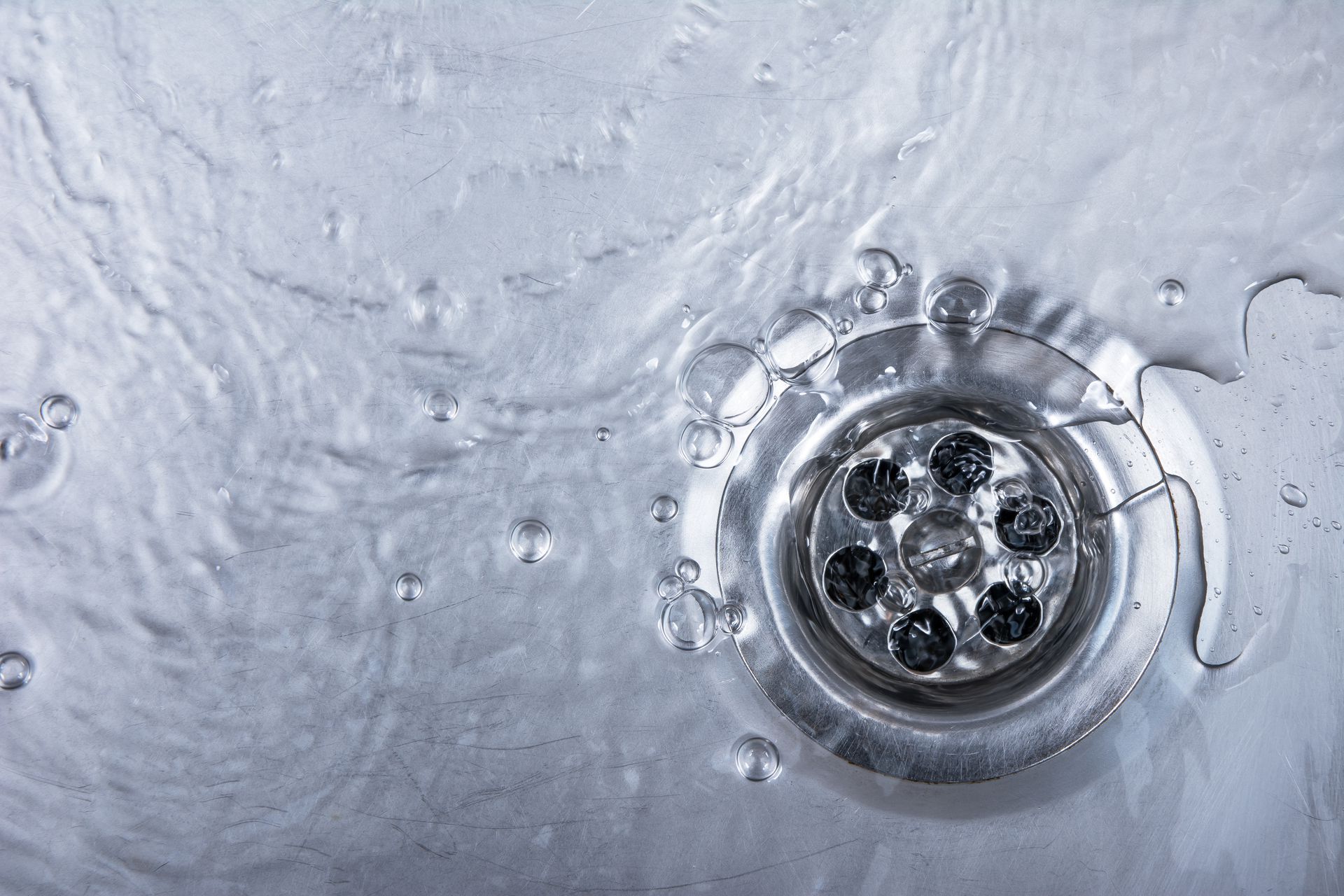 close up of drain with water flowing