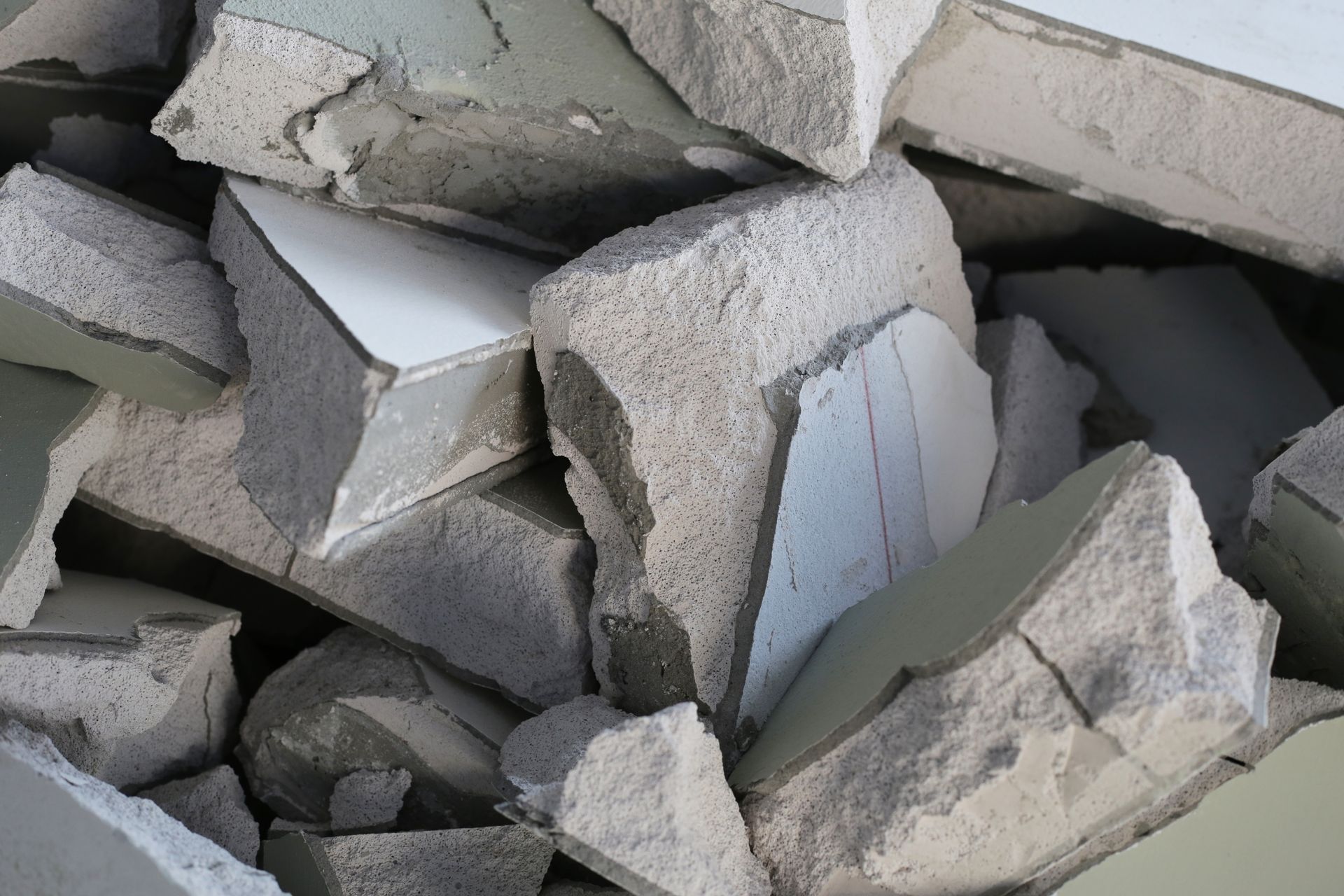 A pile of wood and metal is sitting on top of a pile of gravel.