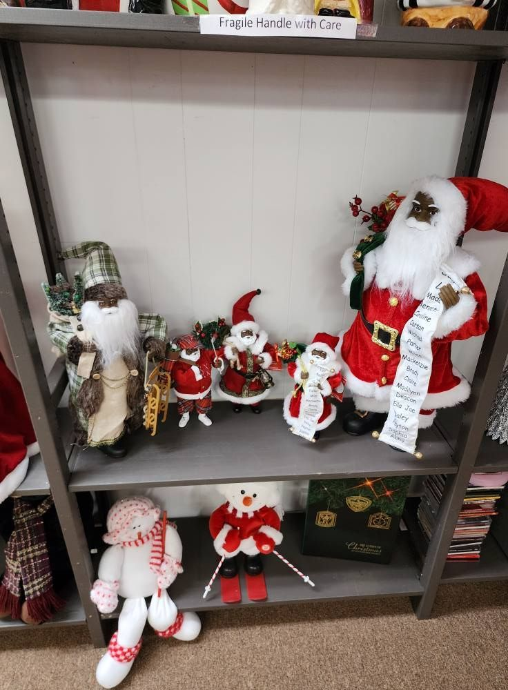 Christmas decorations on shelves: various Santa figures, a snowman, and other holiday items.