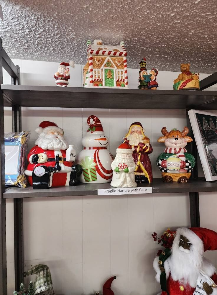 Shelves displaying various Christmas figurines including Santas, a snowman, and a gingerbread house.
