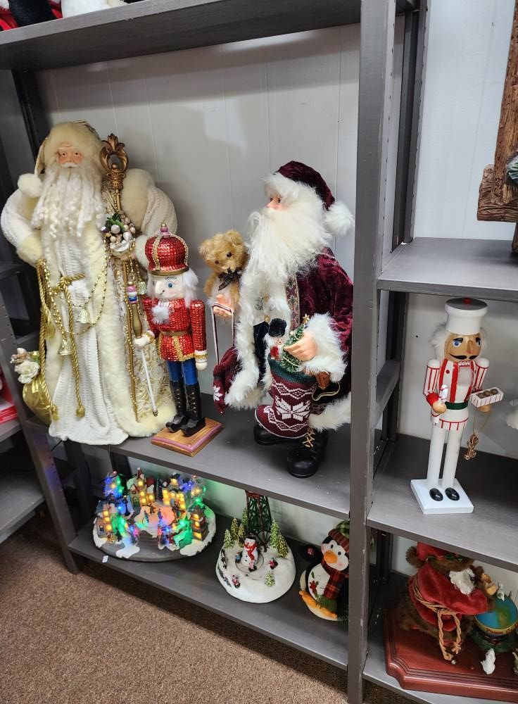 Christmas decorations on shelves, including Santa figures, nutcrackers, and illuminated scenes.