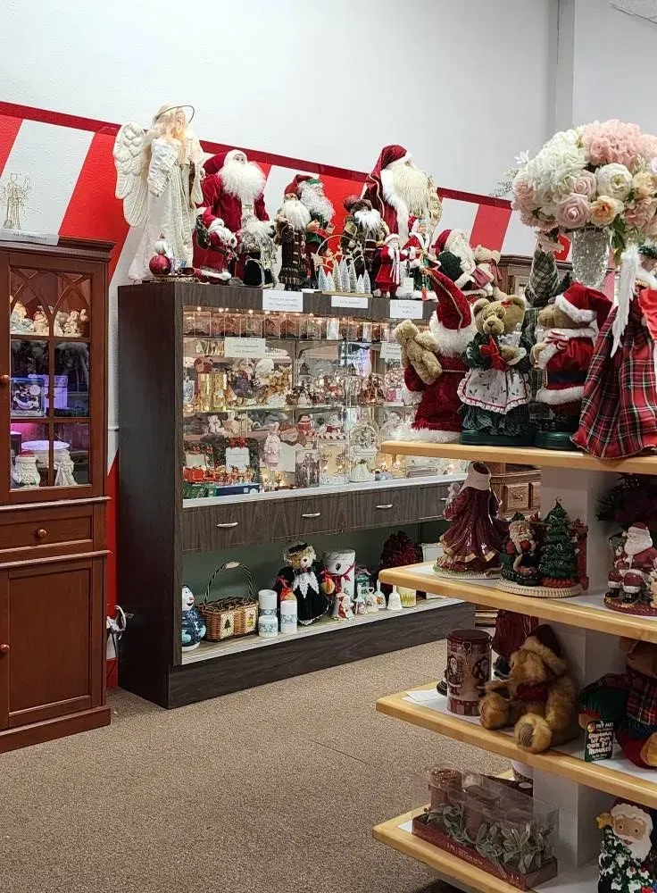 Inside a shop, Christmas decorations, including Santas.