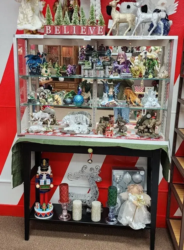 Christmas display cabinet with ornaments, figurines, and 