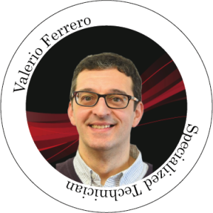 Valerio Ferrero, tecnico specializzato con gli occhiali, sorride in un grafico circolare con sfondo rosso e nero.