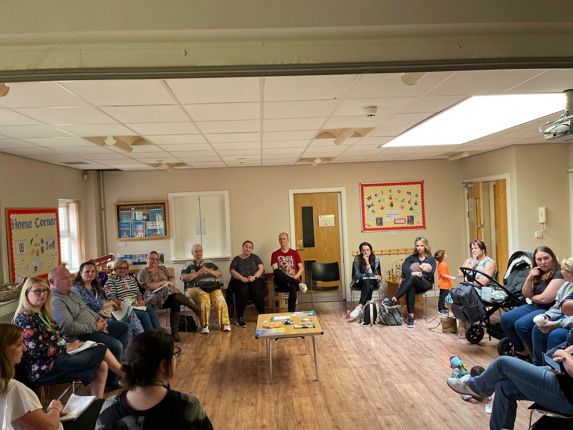 A group of people are sitting in a circle in a room.