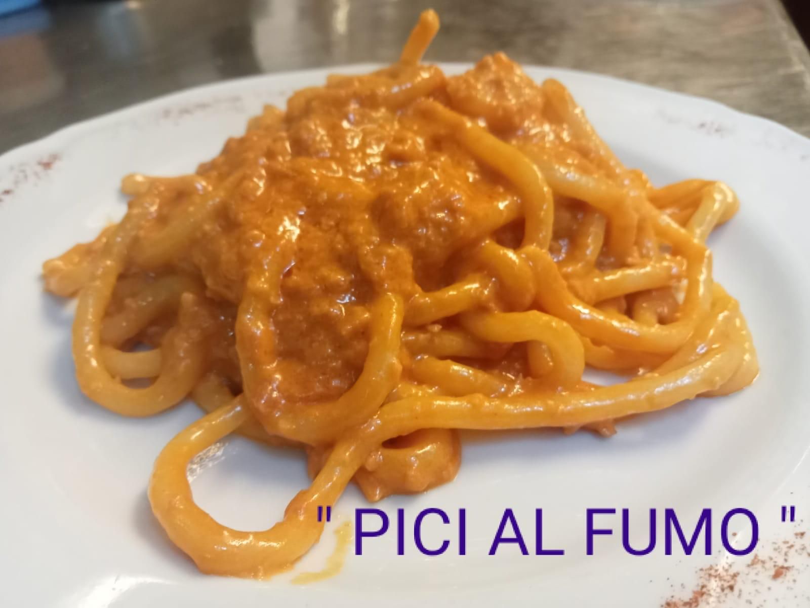 Un piatto di spaghetti con un sugo che dice 