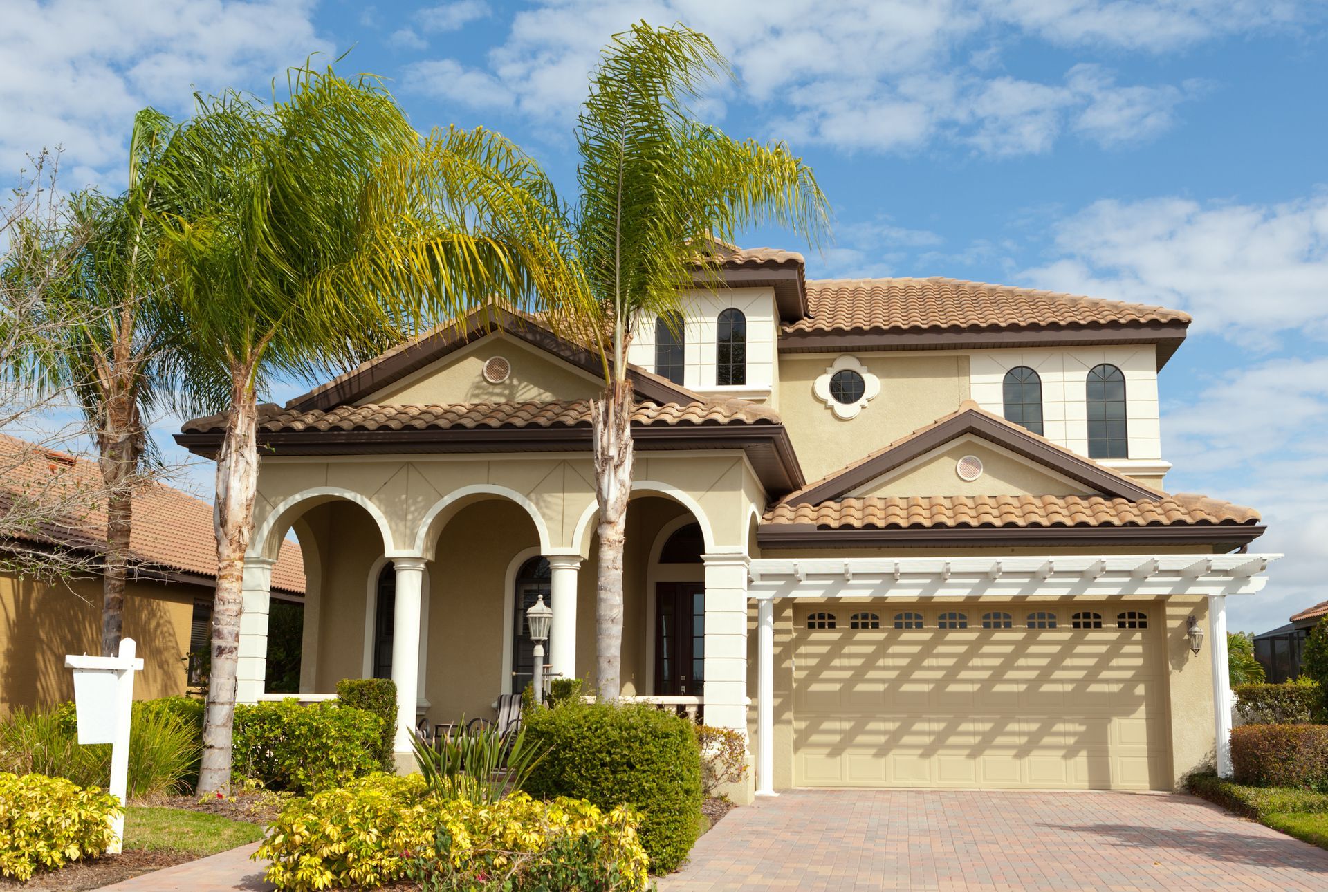 A large house with palm trees in front of it