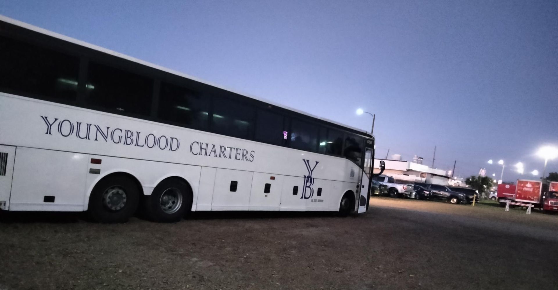 White tour bus driving on a city street