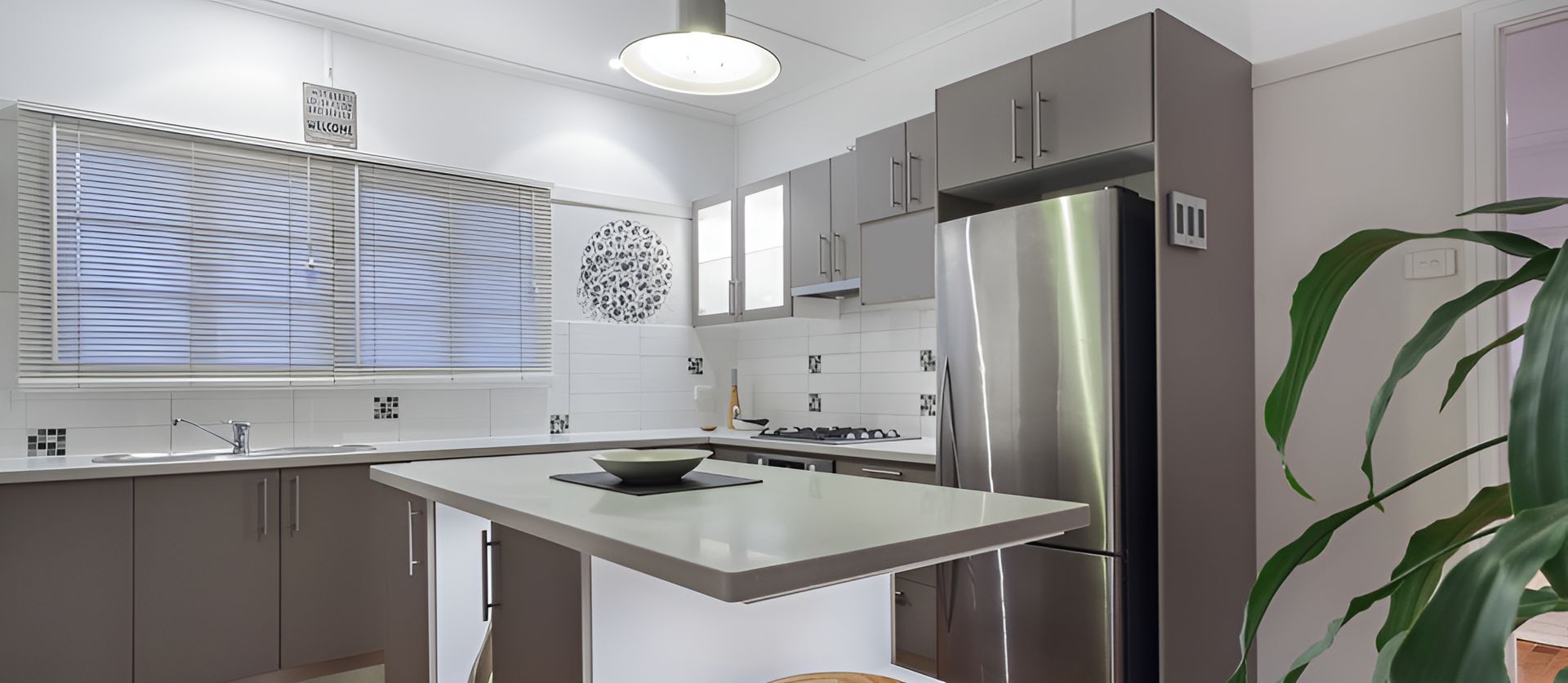 A Kitchen With Stainless Steel Appliances And A Stainless Steel Refrigerator  — Holloway Brothers In Casuarina, NSW