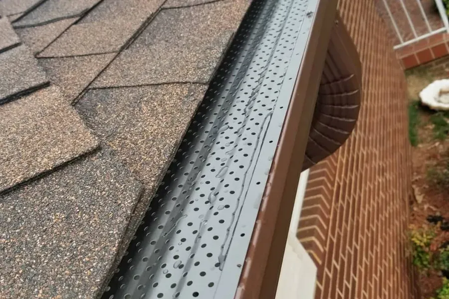A gutter on the side of a brick building