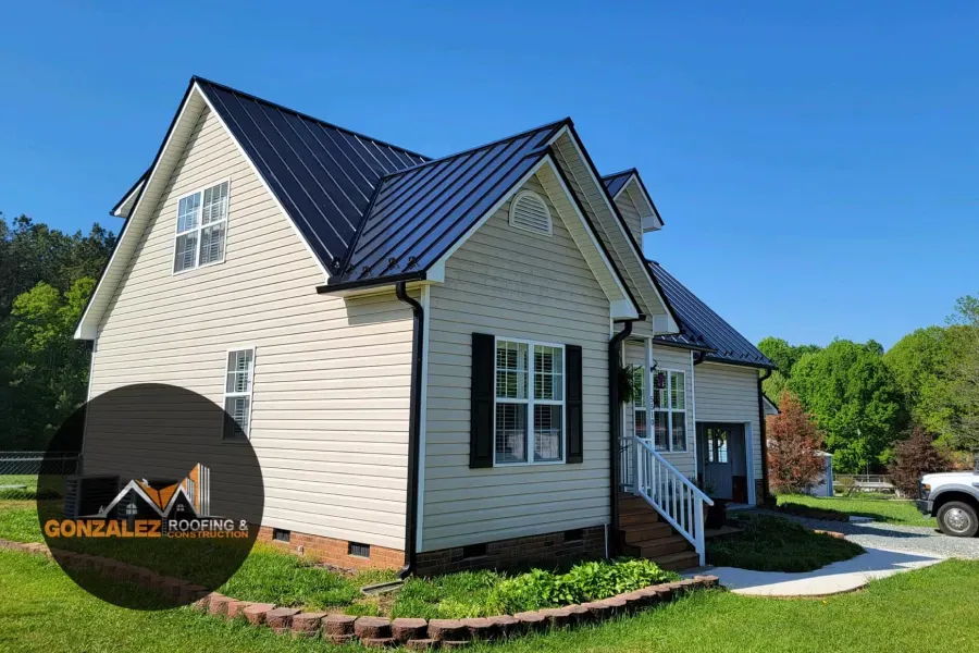 A white house with a black roof and black shutters