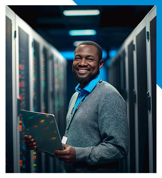 A man is holding a tablet in a server room.
