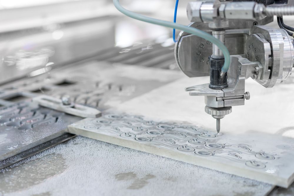 A Machine Is Cutting A Piece Of Tile With Water — D.E.M Solutions Pty Ltd In Caboolture, QLD