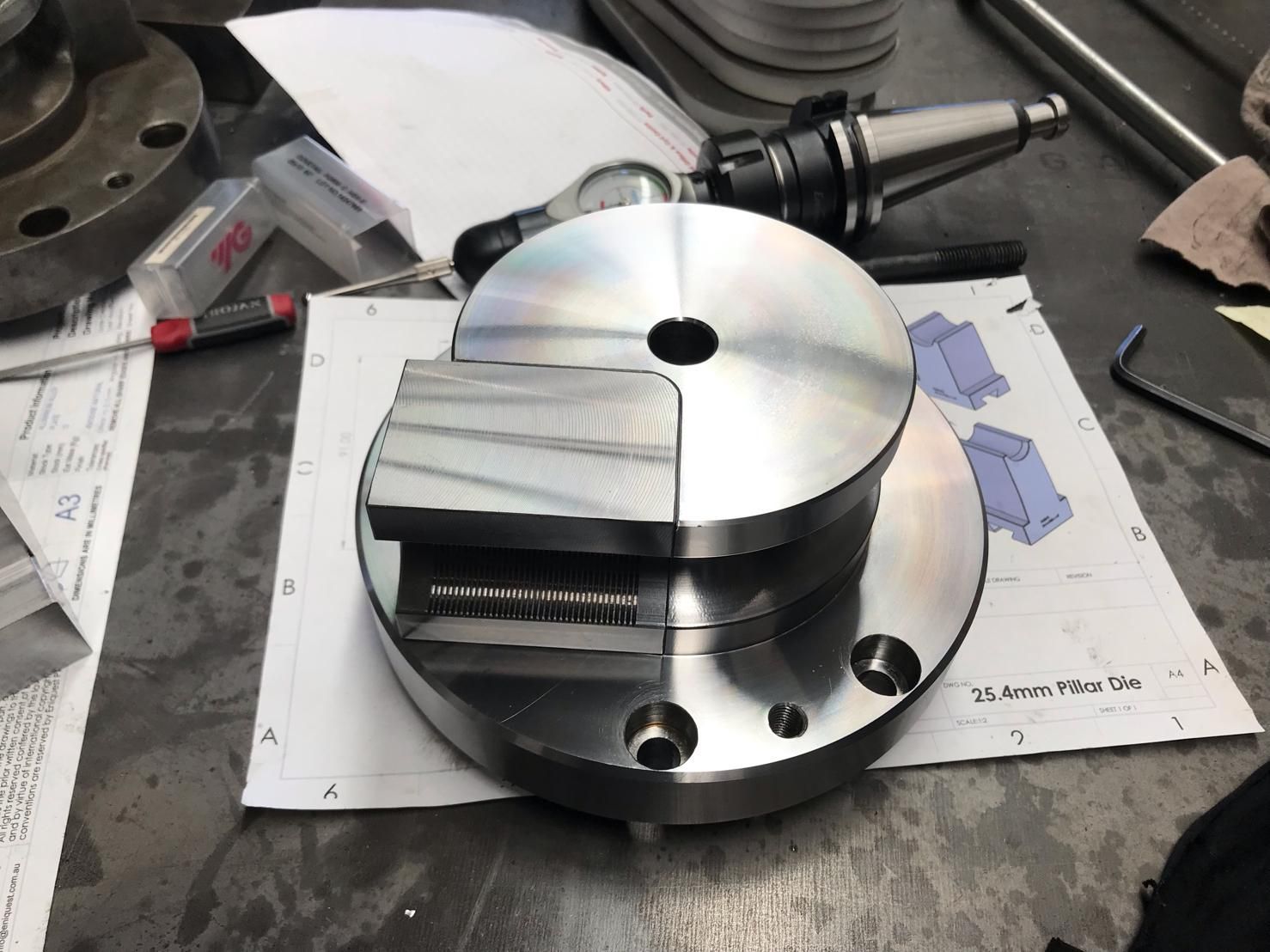 A Piece Of Metal With A Hole In The Middle Is Sitting On A Table — D.E.M Solutions Pty Ltd In Caboolture, QLD