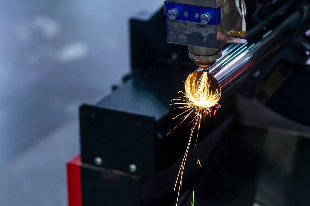 A Machine Is Cutting A Metal Pipe With Sparks Coming Out Of It — D.E.M Solutions Pty Ltd In Caboolture, QLD
