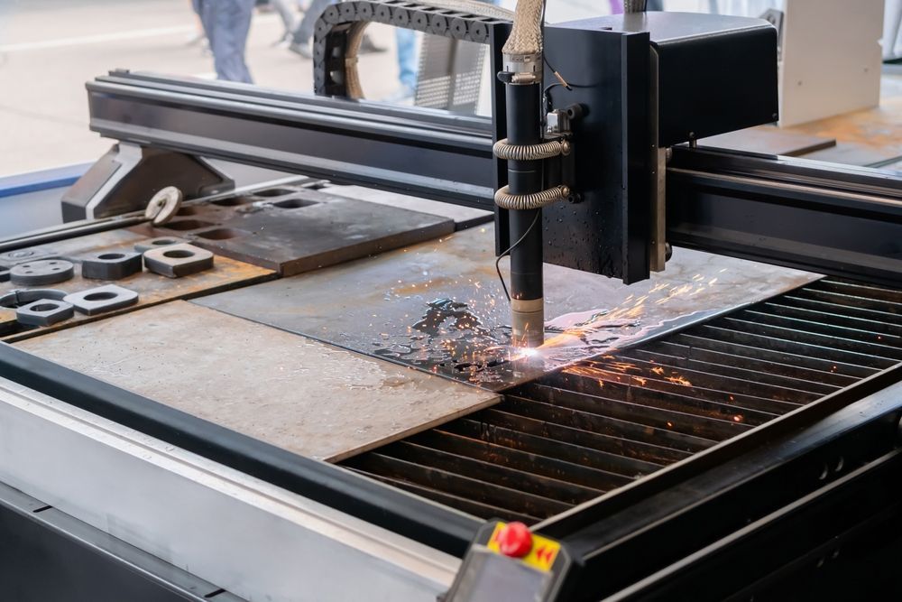 A Machine Is Cutting A Piece Of Metal On A Table — D.E.M Solutions Pty Ltd In Caboolture, QLD