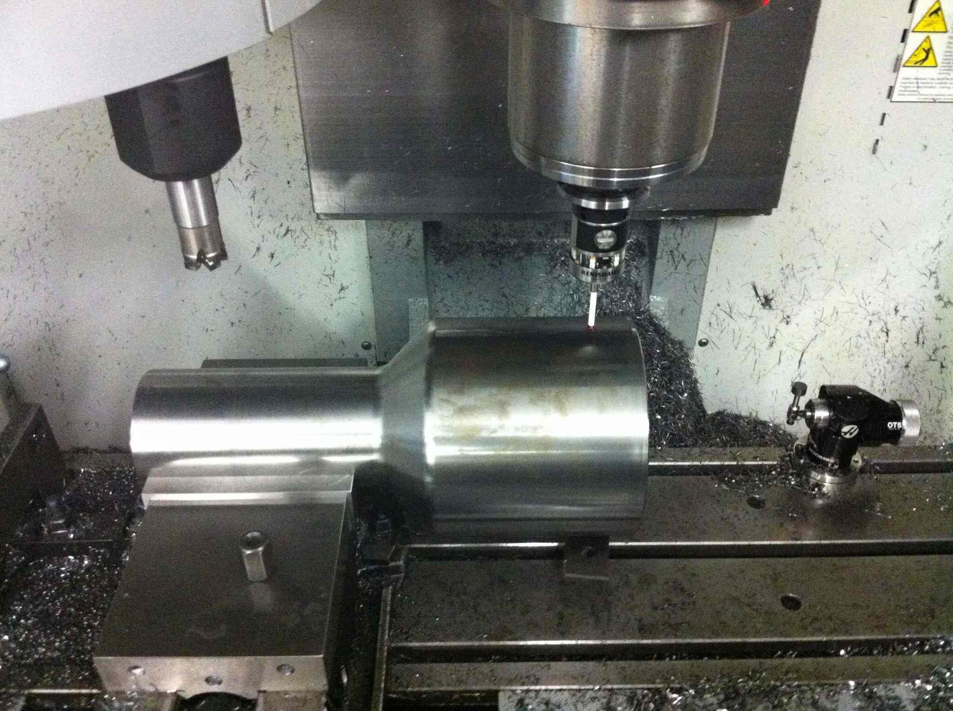 A Machine Is Cutting A Piece Of Metal On A Table — D.E.M Solutions Pty Ltd In Caboolture, QLD