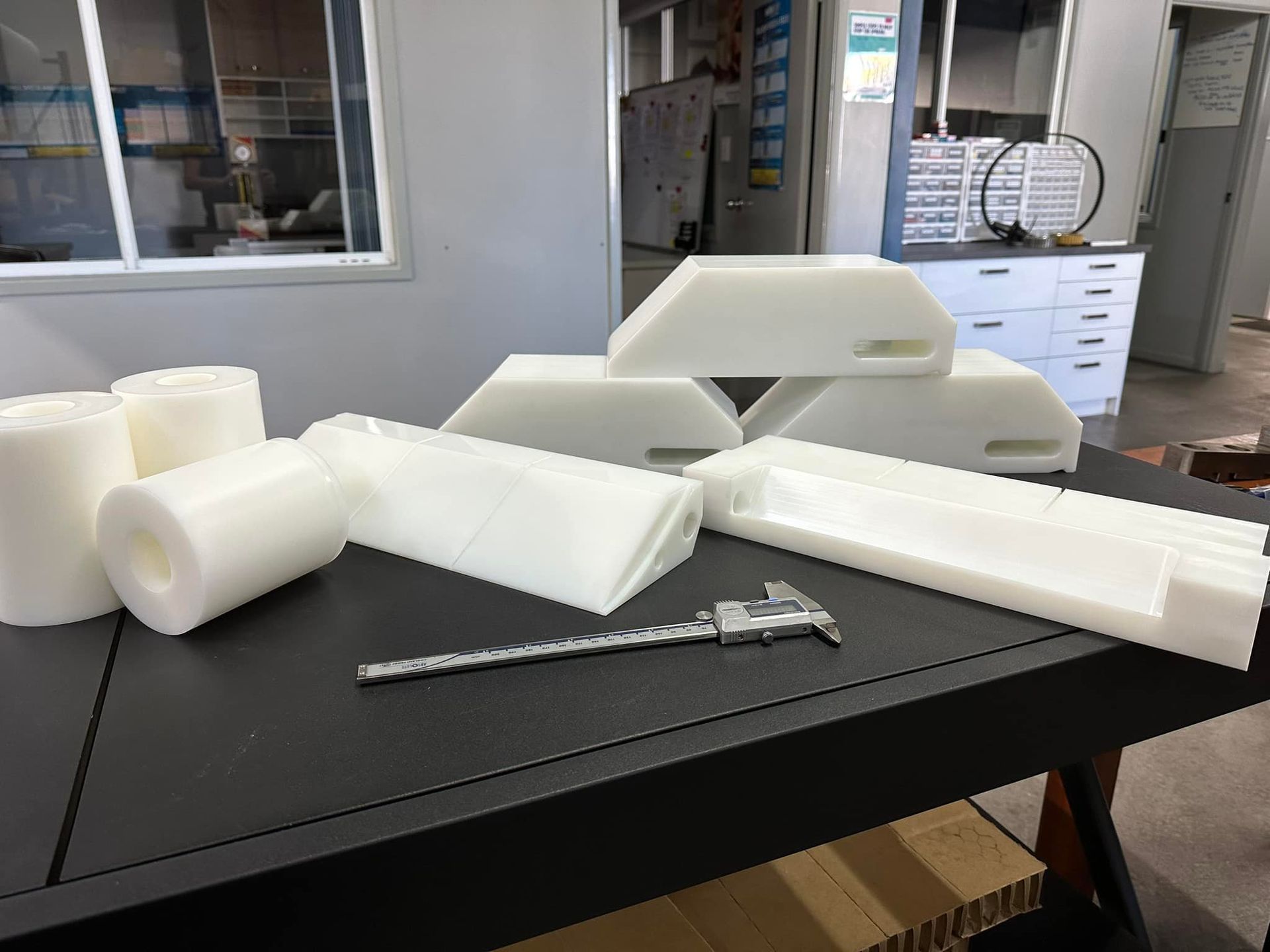 A Table With A Bunch Of White Plastic Pieces On It — D.E.M Solutions Pty Ltd In Caboolture, QLD
