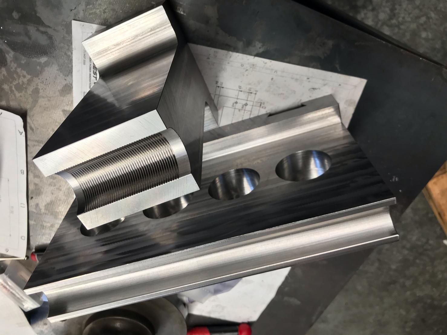 A Piece Of Metal With Holes In It Is Sitting On A Table — D.E.M Solutions Pty Ltd In Caboolture, QLD
